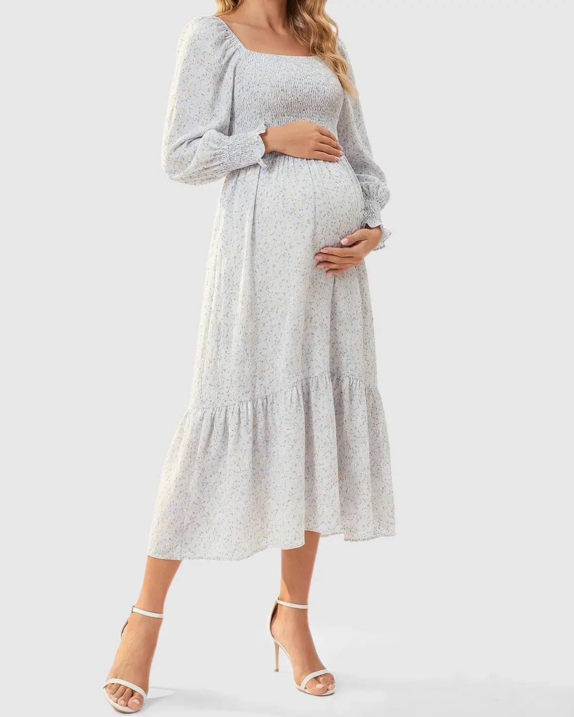 Maternity midi dress with smocked bodice, long sleeves, and soft floral print.