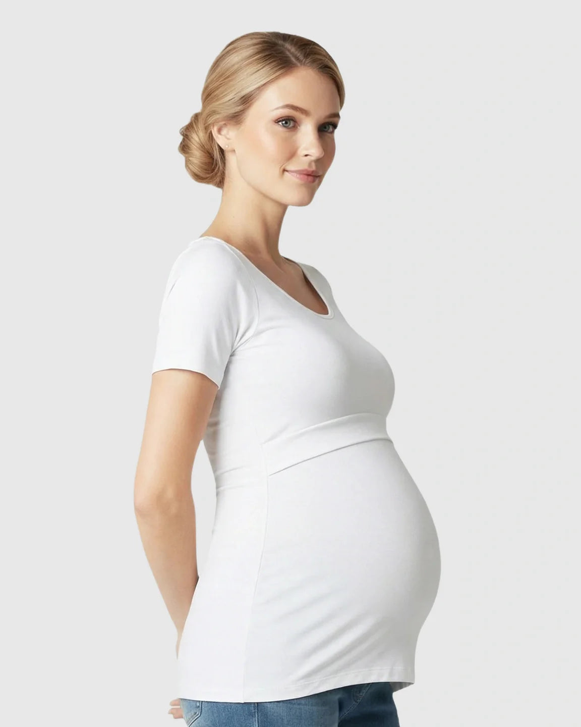 Smiling pregnant woman wearing a white stretch-fit V-neck nursing t-shirt.