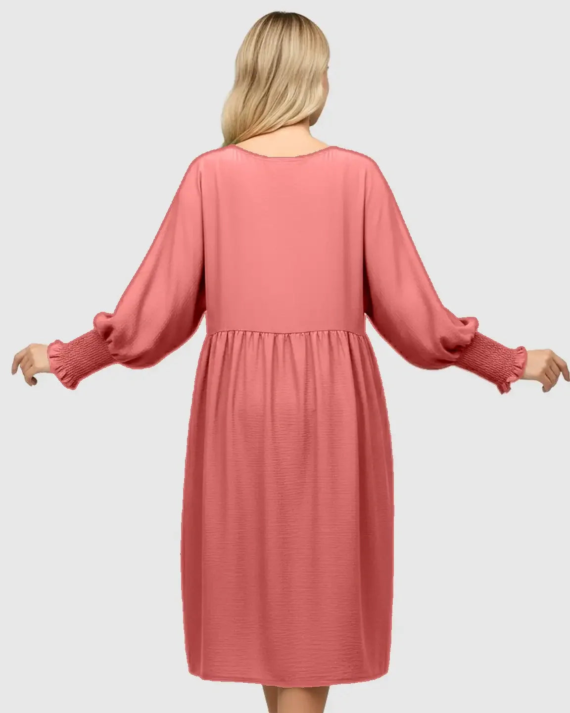 Back view of a coral smocked sleeve casual dress with a round neckline and three-quarter sleeves.