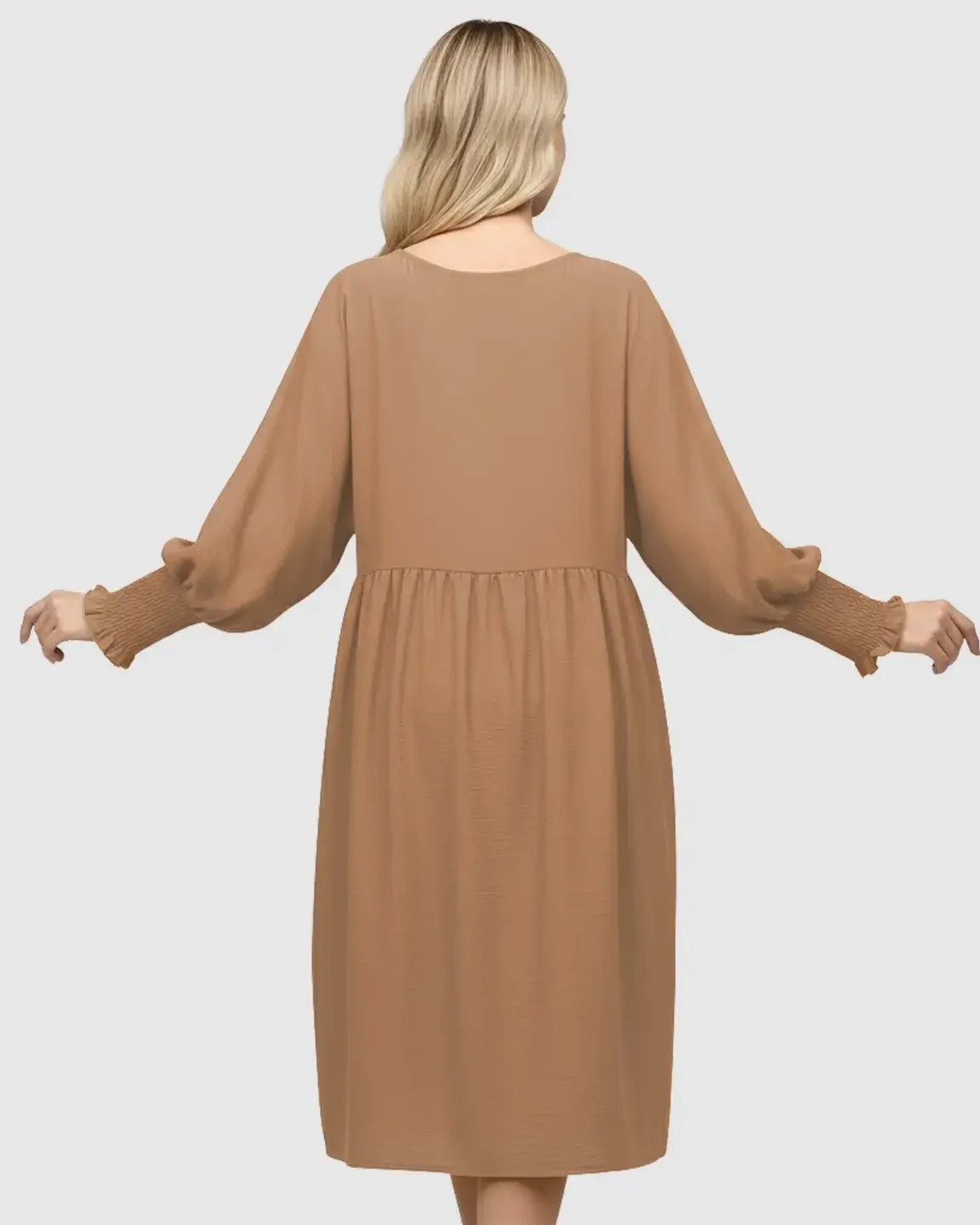 Back view of a blonde woman wearing a brown smocked sleeve casual dress with a round neckline.