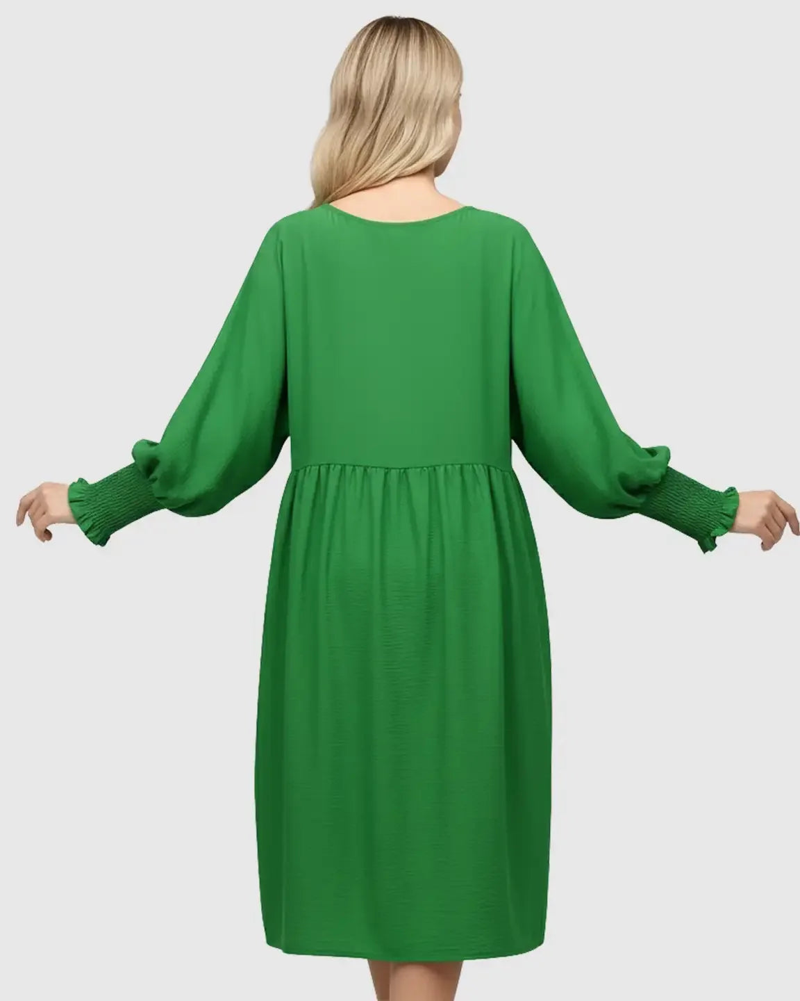 Back view of a green flowy smocked sleeve casual dress with a round neckline.