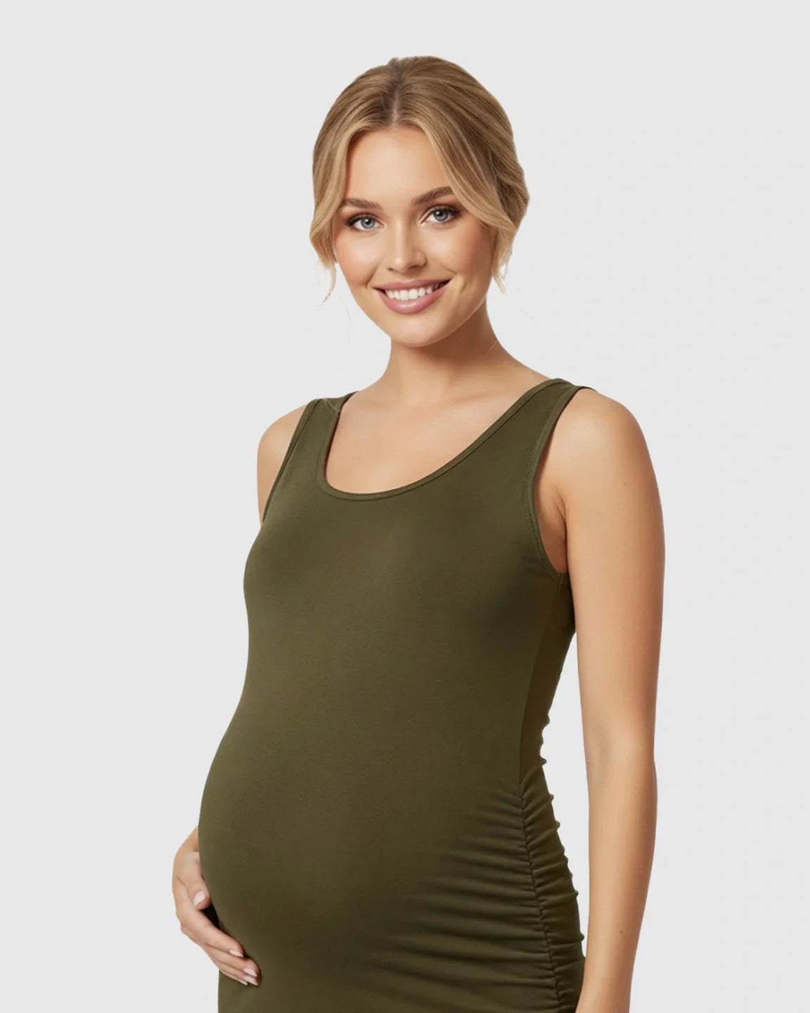 Smiling pregnant woman in a dark olive green sleeveless bodycon maternity dress with side ruching.