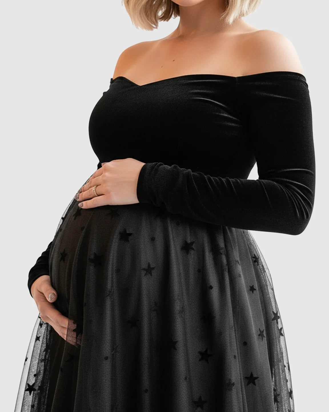 Black off-shoulder velvet maternity midi dress with a star-flocked mesh skirt.