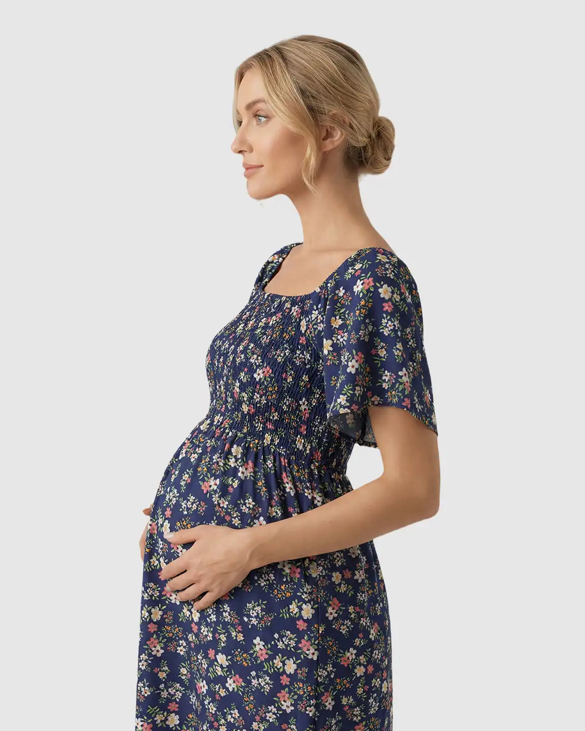 Maternity midi dress in navy floral print with flutter sleeves and smocked bodice.