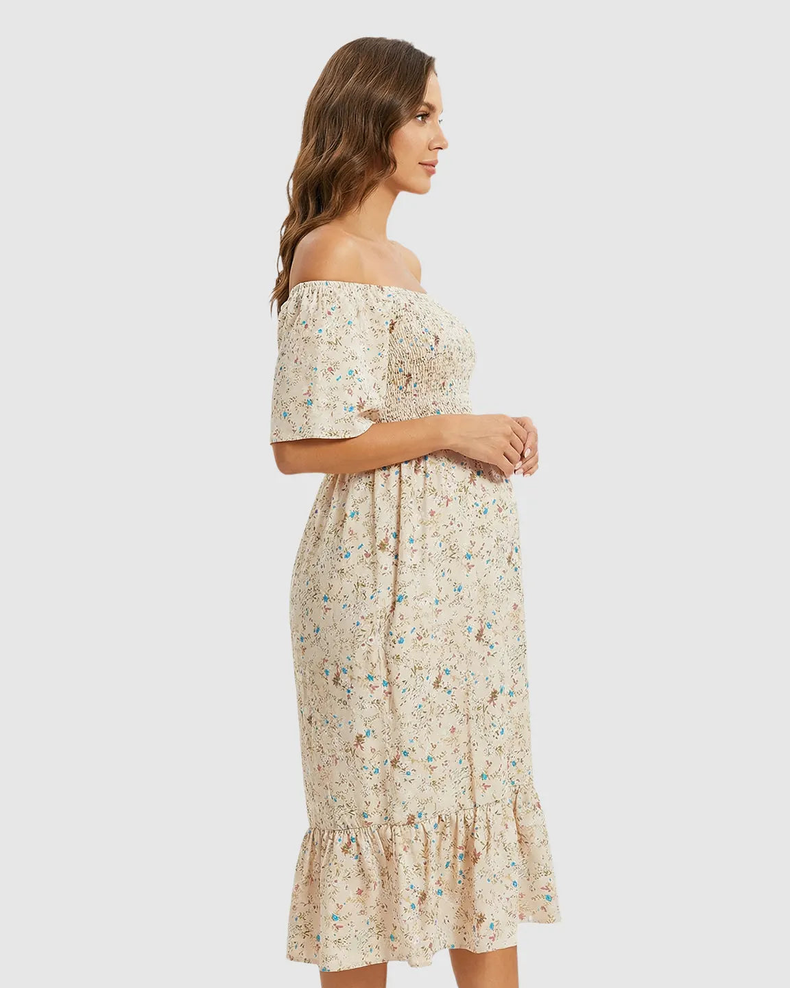Beige floral off-shoulder smocked maternity midi dress with flutter sleeves and tiered skirt.