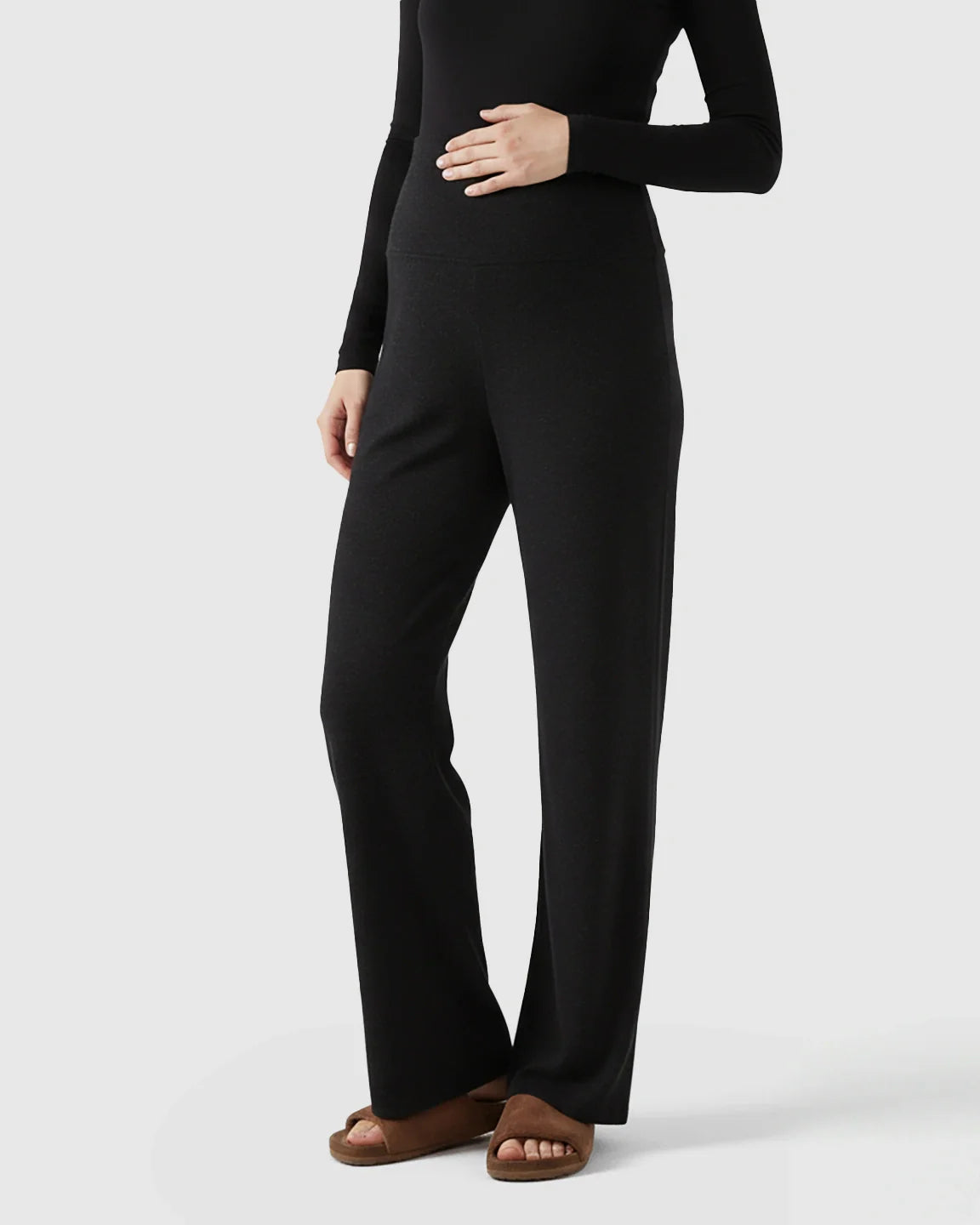 Black fleece relaxed maternity pants with over-belly waistband and wide-leg silhouette.