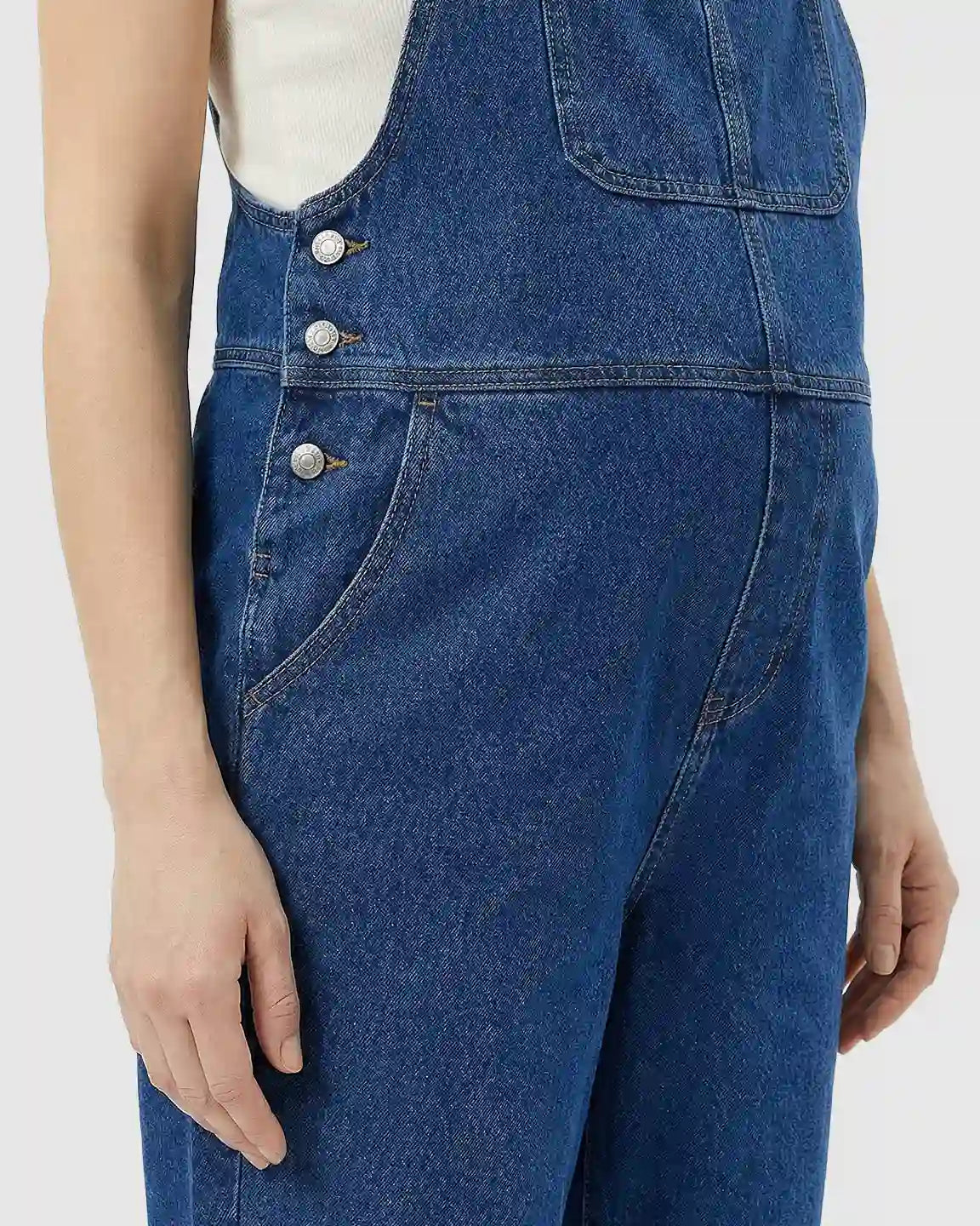 Blue denim maternity jumpsuit with adjustable straps, side buttons, and front pockets.