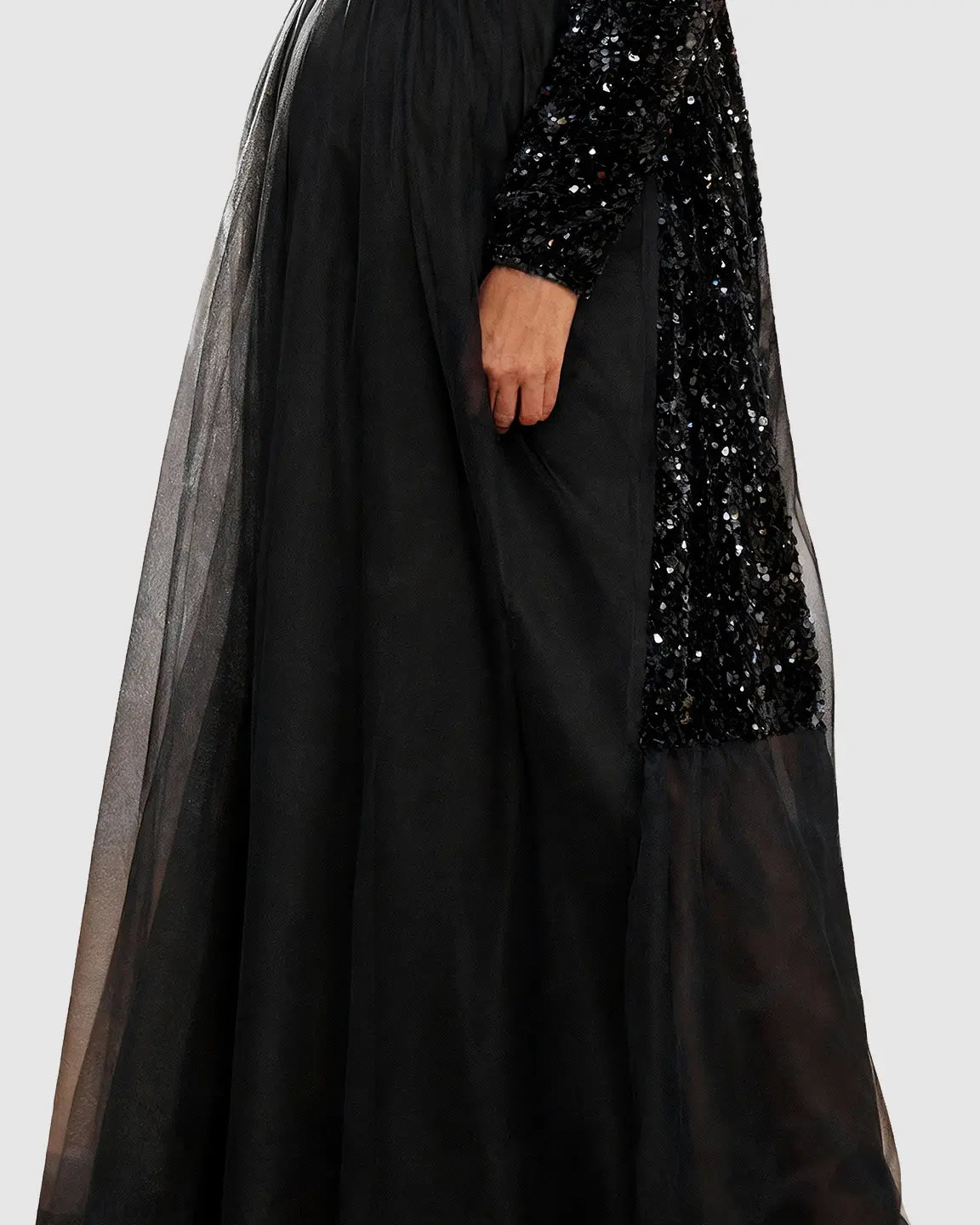 Black sequin long-sleeve empire waist maternity maxi dress with flowing mesh skirt.