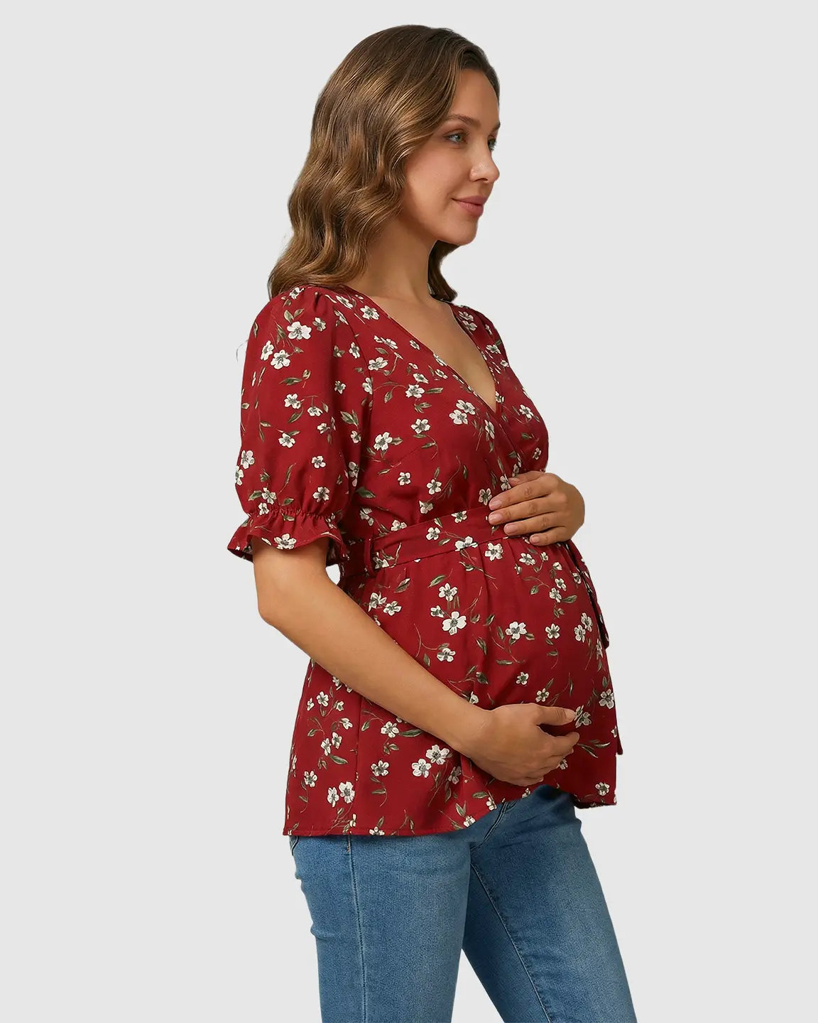 Red floral maternity & nursing top with crossover V-neck, puff sleeves, and tie waist.