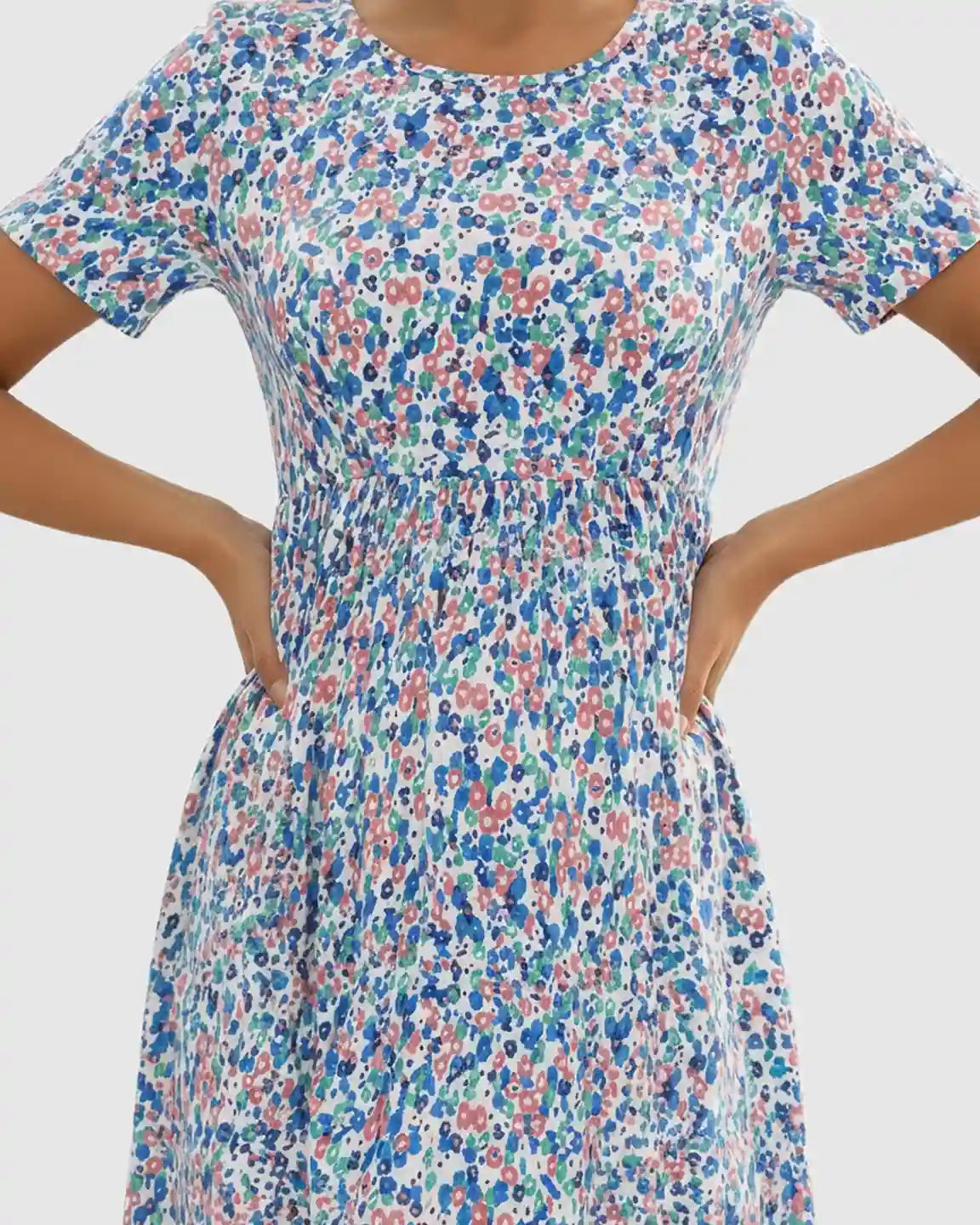Flowy floral-pastoral maternity maxi dress with round neckline, short sleeves, and chiffon skirt.