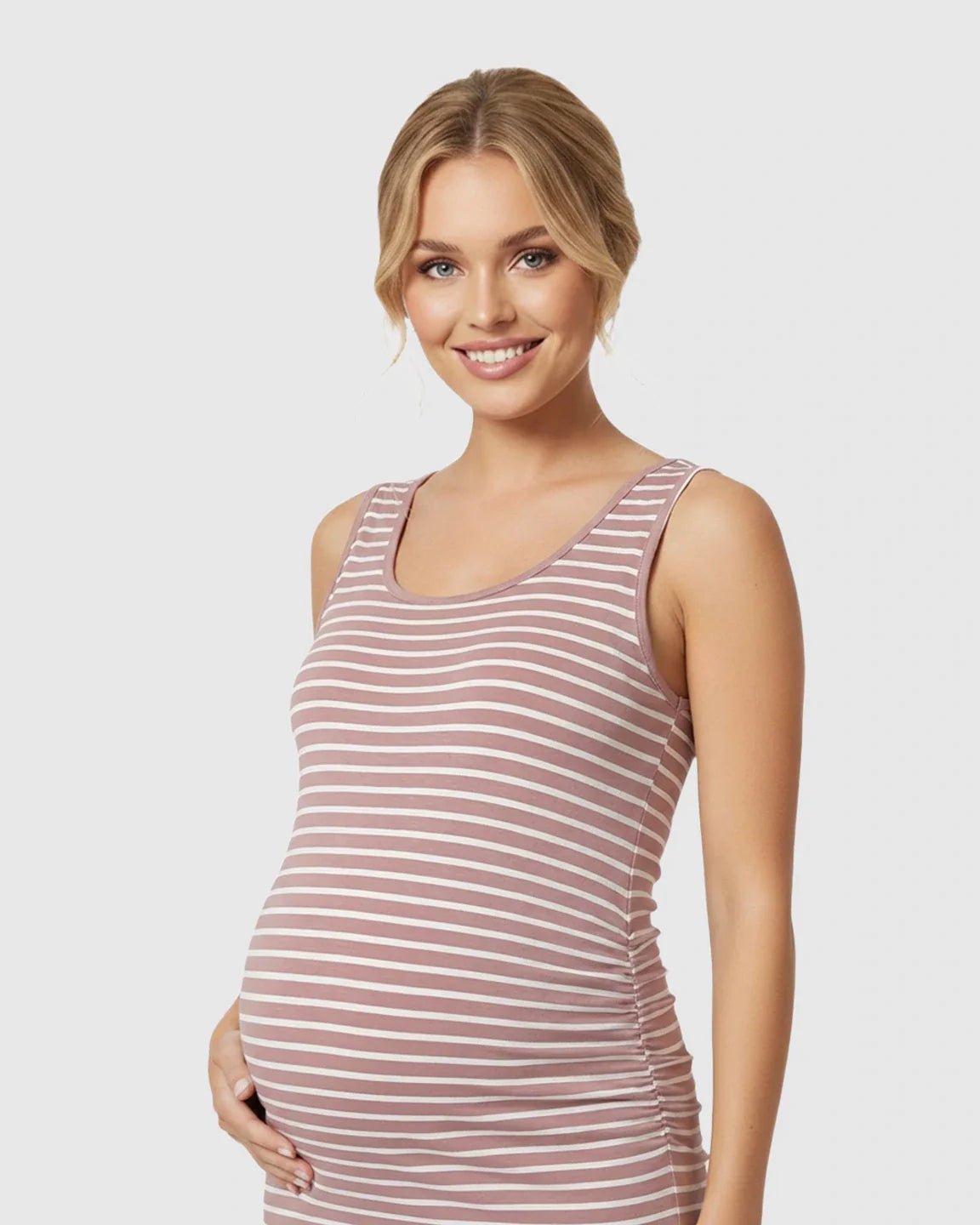 Smiling pregnant woman in a pink and white striped sleeveless maternity bodycon dress with side pleats.