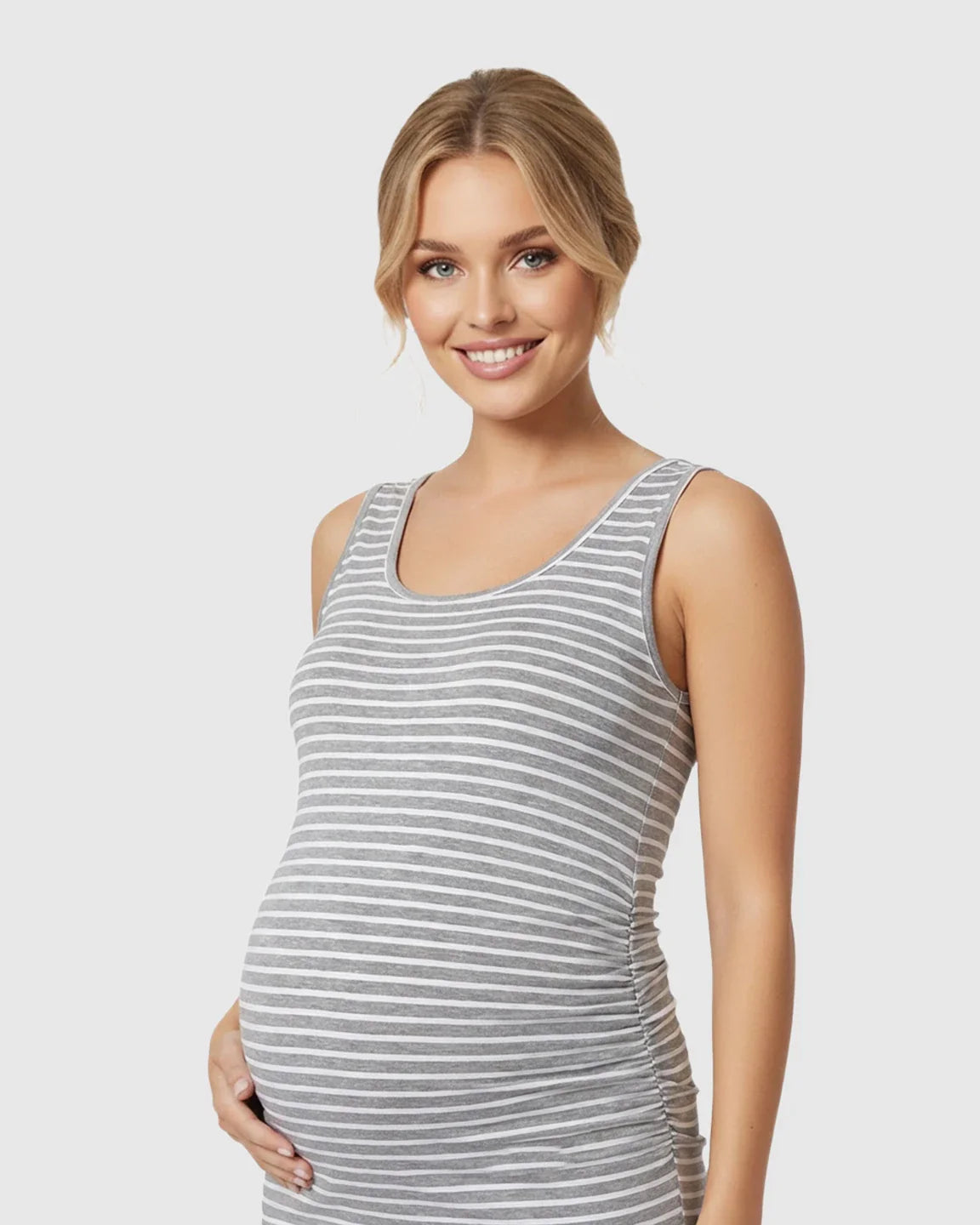 Smiling pregnant woman in a grey and white striped sleeveless bodycon maternity dress with side pleats.