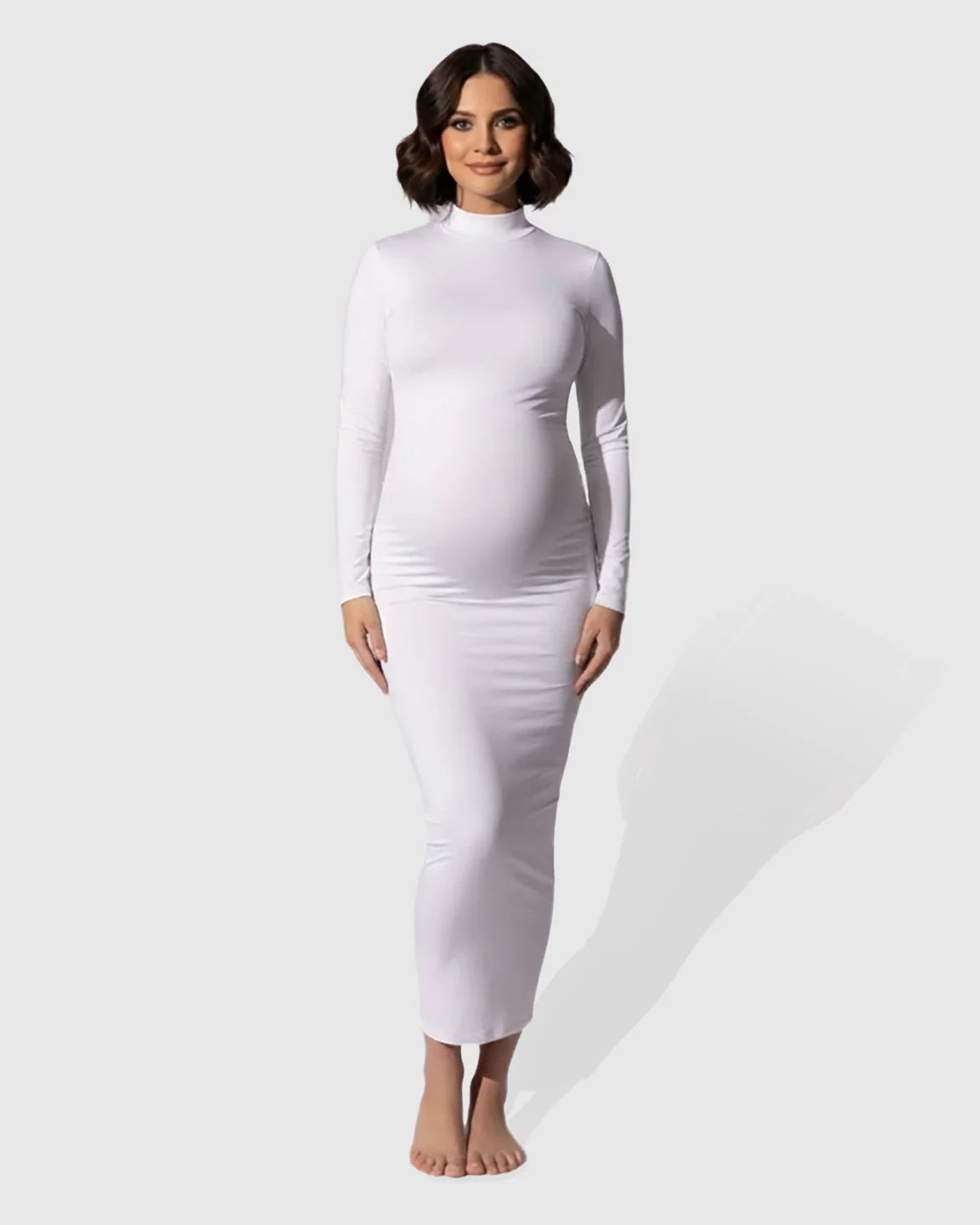 White long-sleeve mock-neck bodycon maternity maxi dress on a model.