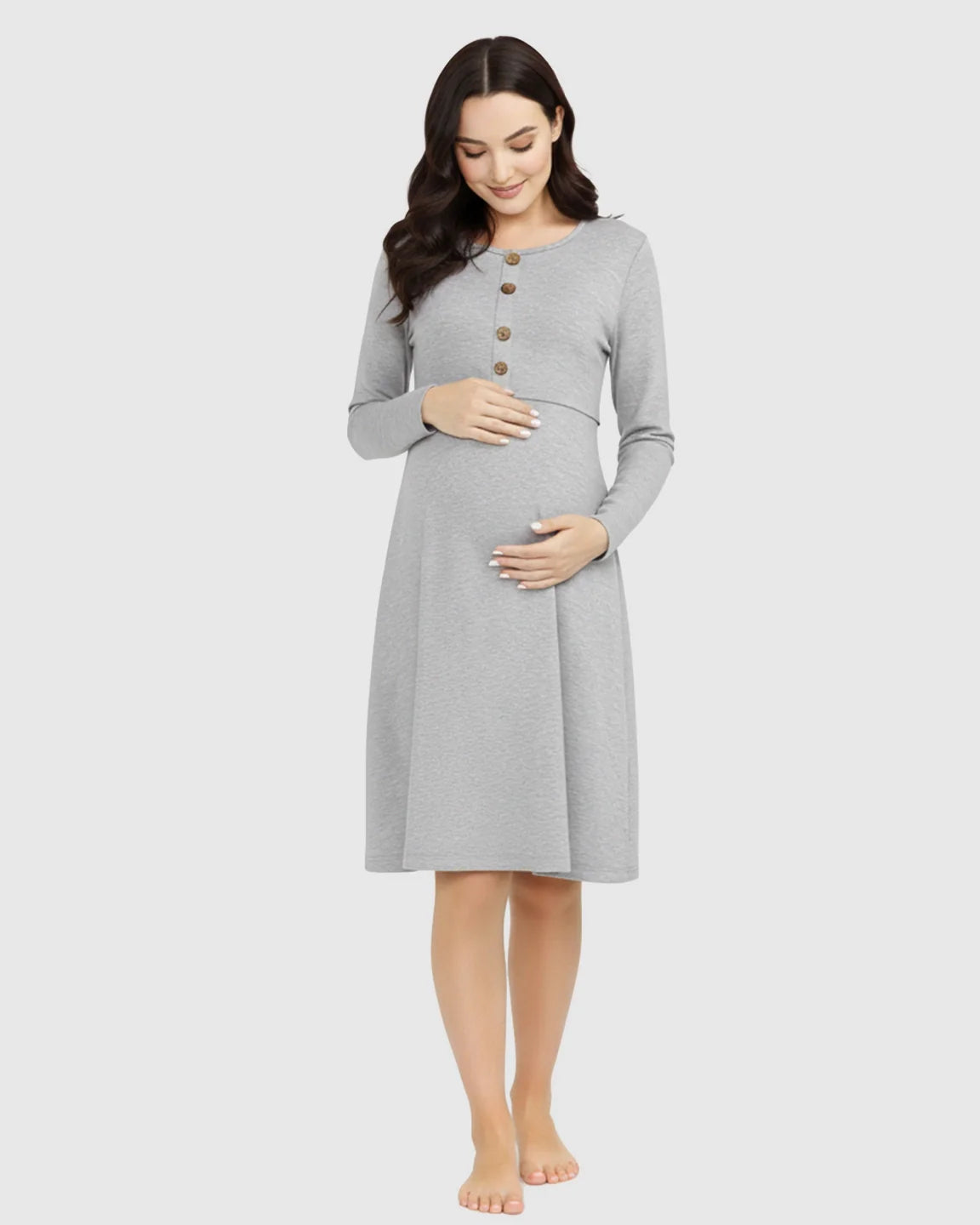 Smiling pregnant woman in a gray long-sleeve empire waist nursing dress with brown buttons.