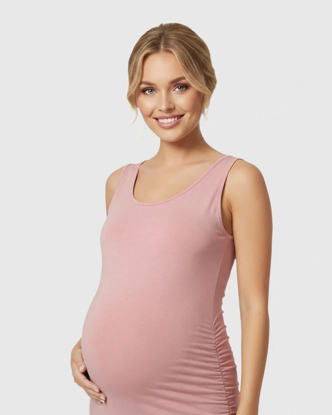 Smiling pregnant woman in a pink sleeveless bodycon maternity dress with side pleats.