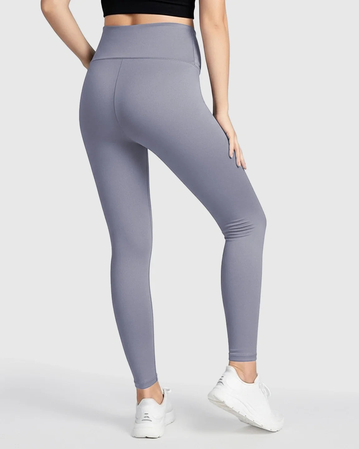 Woman from behind wearing ultra-soft, seamless grey maternity midi leggings with a high, supportive waistband.